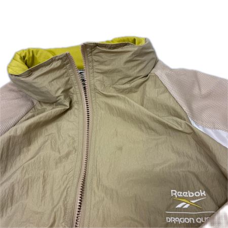 REEBOK リーボック ジャケット ナイロンジャケット SIZE XL ドラゴンクエスト 40周年 RB00160 ベージュ系 x イエロー x ホワイト